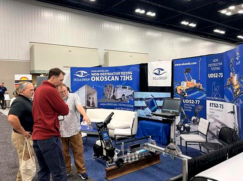 At Railway Interchange 2025, an NDT Supply specialist consults with a visitor about rail flaw detectors